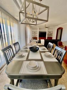 a dining room table with chairs and a bowl on it at Rosarito Beach and pool access apartment 2bd 2b in Popotla
