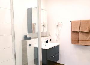 a bathroom with a sink and a mirror at Pension Gästehaus La Mula in Treis-Karden