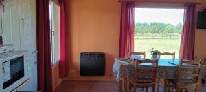 una sala da pranzo con tavolo e finestra di Cabaña Las Lavandas a Trevelin Altre 17 foto