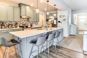 a kitchen with a large island with bar stools at 15 Mi to Dtwn Indianapolis Family-Friendly Home! in Brownsburg
