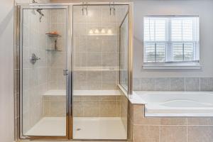 a bathroom with a shower and a tub and a sink at 15 Mi to Dtwn Indianapolis Family-Friendly Home! in Brownsburg +22 photos