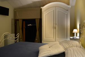 a bedroom with a bed with a white headboard at Il Fienile di Assisi in Assisi