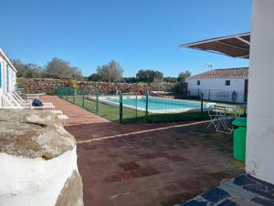 a swimming pool with a fence around it at Monte do Vale in Vila Boim