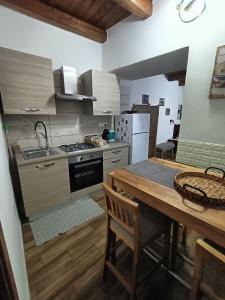 a kitchen with a table and a stove top oven at Raggio di Sole in Iglesias +82 photos