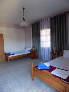 Un dormitorio con dos camas y una gran ventana. en Fanis Rooms, en Kokkino Nero 124 fotos más