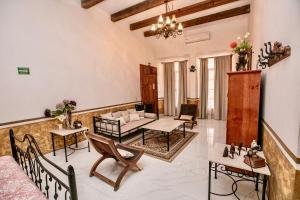 a living room with a couch and tables and chairs at Hotel Hacienda San Isidro in San Isidro Mazatepec
