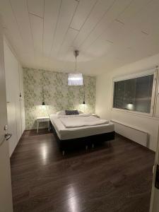 a bedroom with a bed in the middle of the room at River landscape close to the centre, Himos 8km in Jämsä
