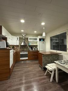 a large kitchen with white appliances and wooden floors at River landscape close to the centre, Himos 8km in Jämsä +17 photos