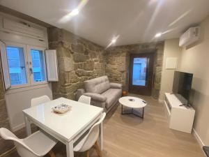 a living room with a couch and a table at O Lar do Rodrigo in Castro Caldelas