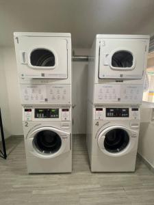 two washing machines and a washer and dryer in a room at Muy Cerca al CC Fundadores, U Autonoma & El Centro in Manizales