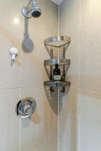 a shower with a shower head and a shower head at Central 2Bed,2Bath, Balcony Apartment Near New Street, Mailbox & Canals at Skyline Apartments in Birmingham