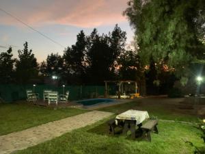 a backyard with a picnic table in the grass at Cabaña la Morocha in Ciudad Lujan de Cuyo