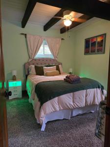 a bedroom with a large bed with a window at Whispering Bears Chalet in Gatlinburg +91 photos