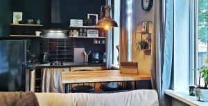 a kitchen with a table with a laptop on it at Yu&Yu loft apartment in Rīga