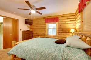 a bedroom with a bed and a ceiling fan at Family Gem Near the Chain of Lakes in Eagle River! in Eagle River