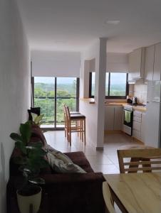 a kitchen and living room with a couch and a table at Departamentos M&A 1 in Puerto Rico +10 photos