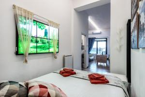 a bedroom with a bed and a window at Orlando's House - Pisa Downtown with View in Pisa