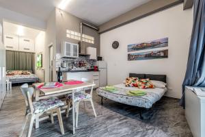 a room with a bed and a table and chairs at Orlando's House - Pisa Downtown with View in Pisa +14 photos