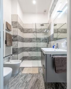a white bathroom with a sink and a toilet at Orlando's House - Pisa Downtown with View in Pisa