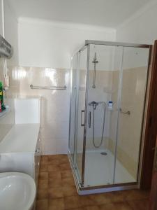 a bathroom with a shower and a toilet and a sink at Casa Baptista I in Marinha Grande