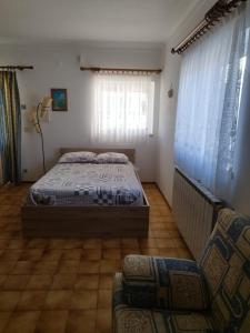 a bedroom with a bed and a chair in it at Casa Baptista I in Marinha Grande