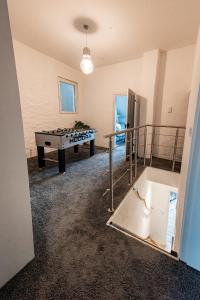 a room with a pool table and a ping pong table at ME LIVING Ferienhaus 130qm Lemgo Zentrum in Lemgo +35 photos