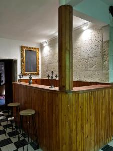 a bar with two stools in a room at Manoir de Manapany in Angliers