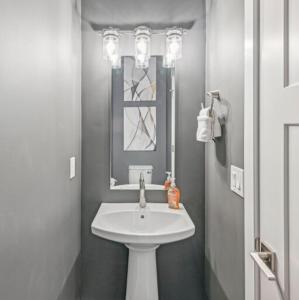 a white bathroom with a sink and a mirror at Townhouse ski spot! in Keetley Junction +17 photos