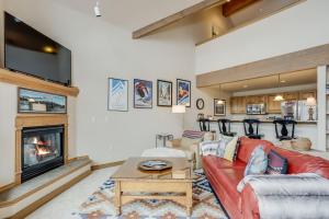 a living room with a red couch and a fireplace at Cozy, Comfy and Convenient in Frisco