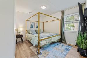 a bedroom with a canopy bed in a room at Modern Farmhouse w King Bed Near Shopping in Streamwood