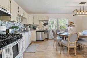 a kitchen with a table and a dining room at Modern Farmhouse w King Bed Near Shopping in Streamwood