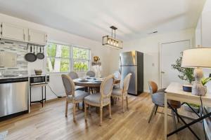 a kitchen and dining room with a table and chairs at Modern Farmhouse w King Bed Near Shopping in Streamwood +14 photos