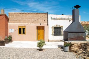 a building with a fire place in front of it at Bodega Ecológica - Rioja Suites in Tudelilla