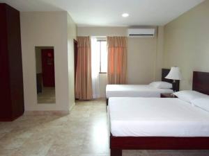 Voodi või voodid majutusasutuse Hotel Marvento Suites toas
