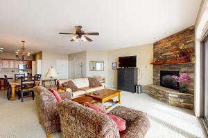 a living room with a couch and a fireplace at Reserve 02-D in Sugar Mountain