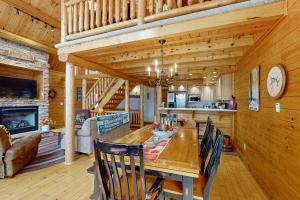 a dining room and kitchen with a table and chairs at 5 Little Acorns in McHenry