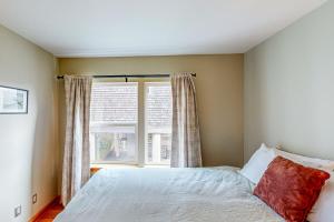 a bedroom with a bed and a window at Netarts Bay and Ocean Views in Netarts