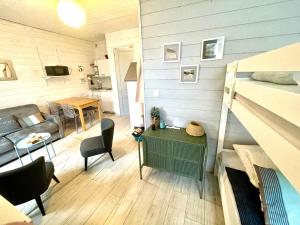 a small living room with a bed and a couch at studio Newport à 50 m du Marché et calme in Le Touquet-Paris-Plage +4 photos