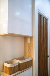 eine Küche mit einem weißen Schrank und einigen Körben in der Unterkunft carpe diem staycation in Lapu Lapu City