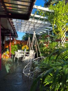 a porch with a swing and a table and chairs at Sun and Shade Apartment in Santa Cruz