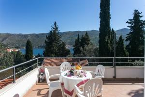 a table and chairs on a balcony with a view at Apartments Marija in Zaton