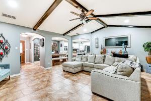 a living room with couches and a ceiling fan at 3 Mi to Downtown McAllen Quiet Home with Pool in McAllen