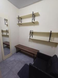 a living room with a bench and shelves on the wall at Residência Dazzi in Rio de Janeiro