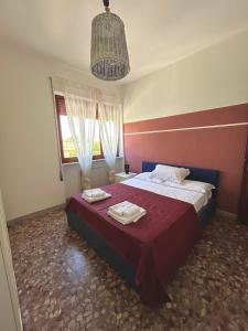 a bedroom with a bed with two towels on it at casa al mare per famiglie 2 in Minturno +7 photos
