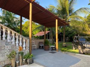 a pavilion with a jeep parked in a yard at Casa de Japaratinga in Japaratinga
