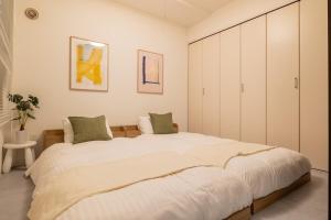 Postel nebo postele na pokoji v ubytování Cozy Stay Sapporo East