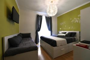 1 dormitorio con cama, sofá y lámpara de araña en Jubilee 2, en Roma