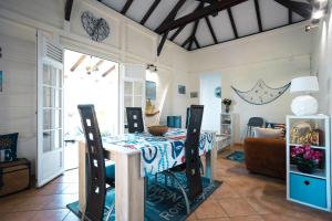 a dining room with a table and a couch at Villa Girofle in Le Vauclin