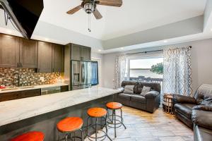 a kitchen and living room with a counter and stools at Charming Bear Lake Cottage with Dock and Paddleboards! in Bear Lake