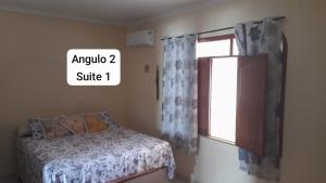 a bedroom with a bed next to a window at Casa luxo para a Cop 30 in Ananindeua